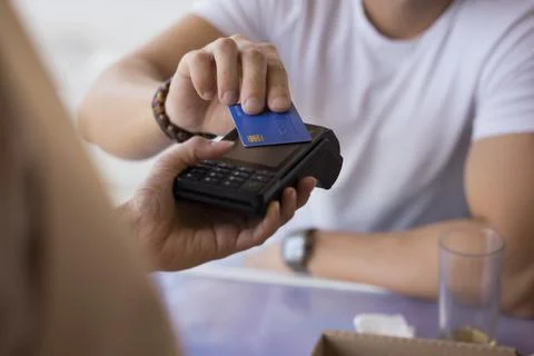 Client paying bill using cashless technology, close up Stock Photos