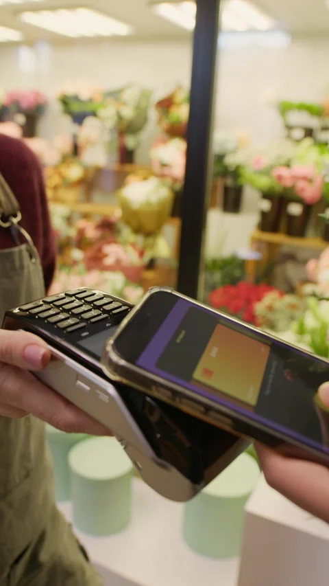 Client Paying by Smartphone for Purchase in Florist Shop Stock Footage 321338264
