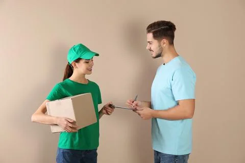 Client receiving parcel from delivery service courier on color background 스톡 사진