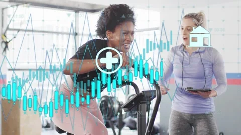 Client riding bike and pushing while coach tapping tablet showing energy icons Stock Footage 333132603
