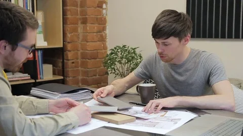 Client selects samples of materials that the designer shows him. Stock Footage 77609100