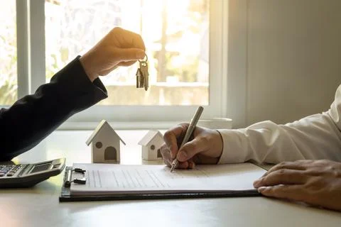 The client is signing a real estate contract with an approved mortgage requ.. Stock Photos