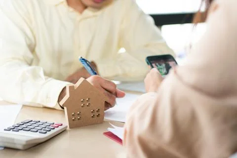 Client signs home loan document to buy homes with real estate property agent  Photos