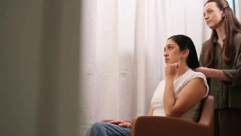 Client smiling and interacting with a spa cosmetologist during a relaxed moment Stock Footage 321517403