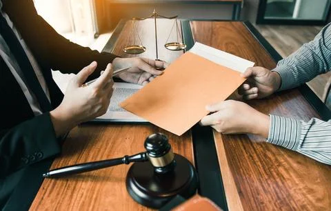 Client is submitting information on the paper of the prosecution document t.. Stock Photos