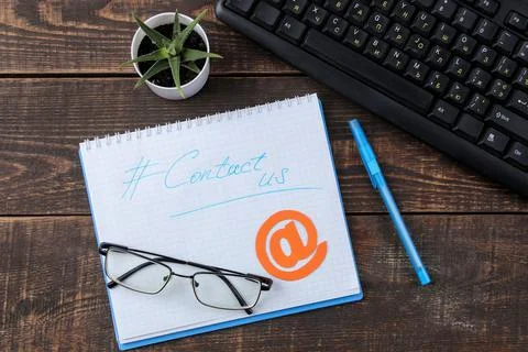 Client support service. Contact us for feedback. desktop with notepad and gla Stock Photos