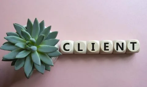 Client symbol. Concept word Client on wooden cubes. Beautiful pink backgrou.. Foto stock