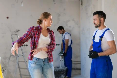The client tells the foreman how to make repairs Stock Photos