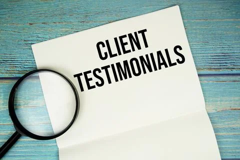 Client Testimonials text written on notepad with magnifying glass flat lay .. Stock Photos
