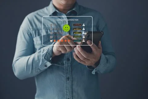 A client use smartphone select on the five star to give satisfaction in ser.. Stock Photos