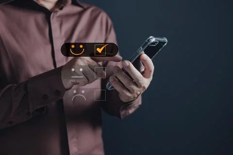 A client use smartphone select on the five star to give satisfaction in ser.. Stock Photos