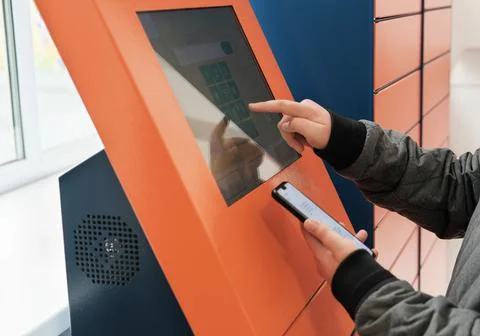 Client using automated self service post terminal machine or locker to receiv Photos