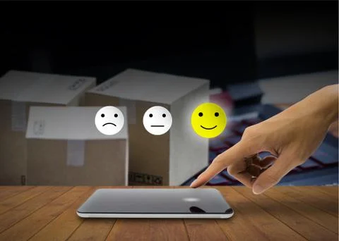 The client using hand choose happy face smile on smartphone. Stock Photos