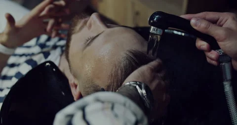 A client washes his head in the beauty salon after the milling procedure Stock Footage 139756913