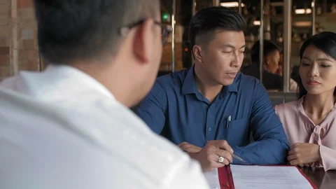 Clients Discussing Contract with Lawyer Stock Footage 111011326