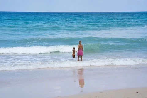 Clients on th beach watching the waves Stock Photos