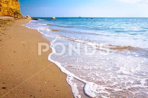 Cliff above idyllic and peaceful bay Stock Photos