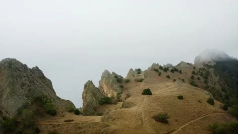 The cliff above the sea, the sharp rocks and stones, the fog obscures the view Stock Footage 220632560