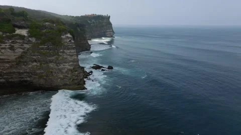 Cliff aerial top down view of a rocky coastline in Uluwatu, Bali. Stock Footage 253421744