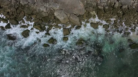 Cliff aerial top down view of a rocky coastline in Uluwatu, Bali. Stock Footage 253422198