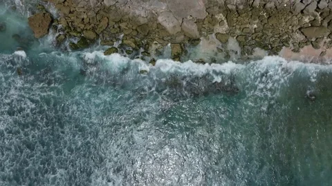 Cliff aerial top down view of a rocky coastline in Uluwatu, Bali. Stock Footage 253774999