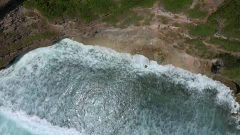 Cliff aerial top down view of a rocky coastline in Uluwatu, Bali. Stock Footage 256223524