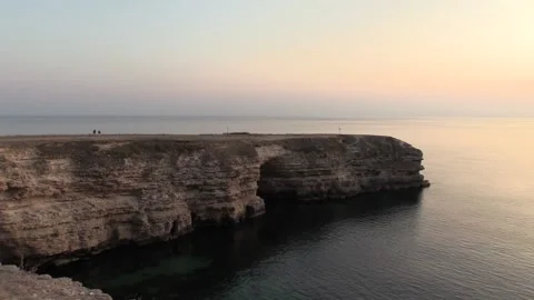 Cliff with an arch on the background of the sea, sunset Stock Footage 145733423