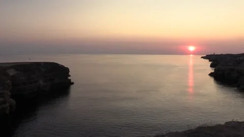 Cliff with an arch on the background of the sea, sunset Stock Footage 145733429