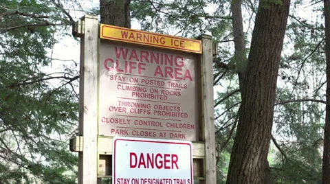 Cliff area warning in forest tilt shot Stock Footage 36000963