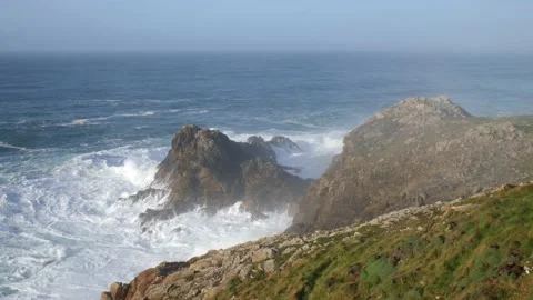 A cliff on the Atlantic. Waves hit the rocks with full force. Stock Footage 135149532