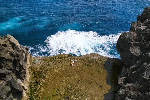 A cliff broken by an ocean wave. The cliff is washed by powerful waves of t.. Stock Photos
