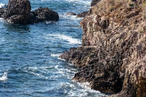 Cliff cliffs and sea wave on a mediterranean island Stock Photos