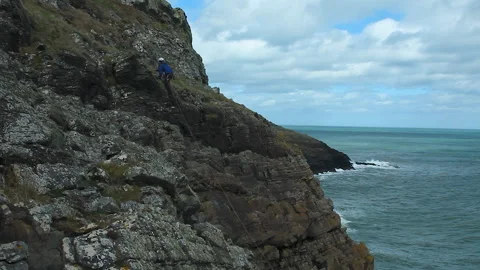 Cliff climbing by the ocean Stock Footage 236709940