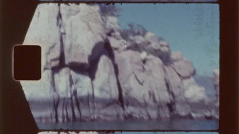 Cliff Diver Jumping Off a Rock Cliff Into the Ocean Water Below Video stock 208736242
