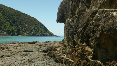 Cliff edge with point other side of sea Stock Footage 260850467