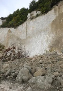 Cliff eroded by natural elements and weather with slide Stock Photos