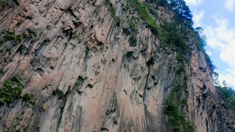 Cliff Face Against Blue Sky Natural Setting 4K Real Shot Stock Footage 320063399