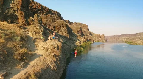 Cliff jumping in to the clear water. Stock Footage 65966595