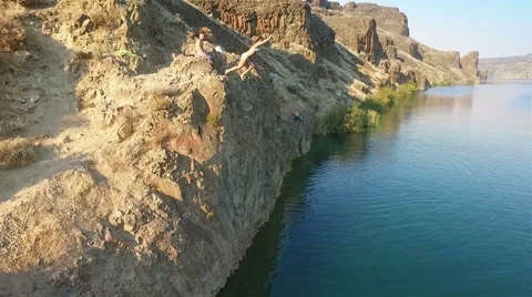 Cliff jumping into the clear water. Stock Footage 65966737