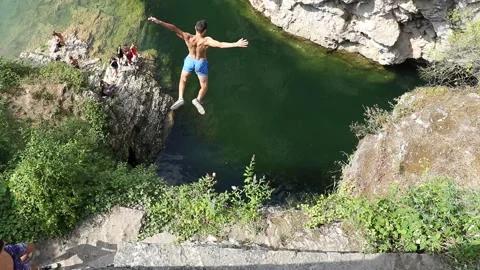 Cliff jumping, dangerous jump from rocks into a river in france, freedom, free Stock Footage 138520612