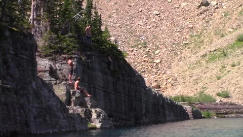 Cliff Jumping (Gainer) into 36 degree water in montana Stock Footage 146151220