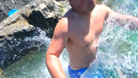 Cliff Jumping Man into Clear Blue Water, Slow Motion High Rock Jump Fun Travel Video stock 162417529