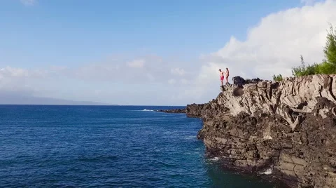 Cliff Jumping into Ocean. Aerial View Slow Motion. Young Man Jumps off Cliff  Vidéo 57223133