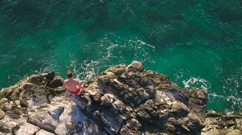 Cliff Jumping into Ocean. Aerial View Slow Motion. Young Man Jumps off Cliff  Stock Footage 57223166