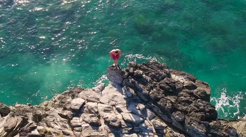 Cliff Jumping into Ocean. Aerial View Slow Motion. Young Man Jumps off Cliff  Видео 57223207