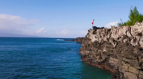 Cliff Jumping into Ocean. Aerial View Slow Motion. Young Man Jumps off Cliff  Stock-Footage 57223223