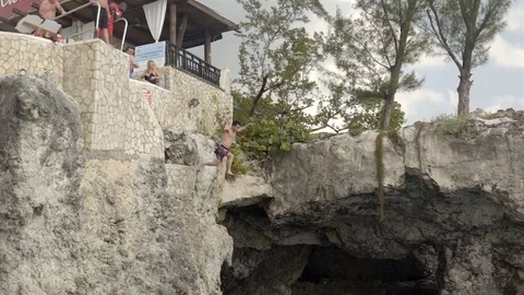Cliff jumping at Ricks Cafe in Negril, Jamaica. Filmed in Super Slow Motion. Stock Footage 73138190