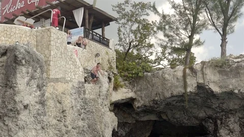 Cliff jumping at Ricks Cafe in Negril, Jamaica. Filmed in Super Slow Motion. Stock Footage 73138258