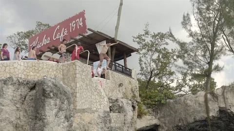 Cliff jumping at Ricks Cafe in Negril, Jamaica. Filmed in Super Slow Motion. Stock Footage 73138306