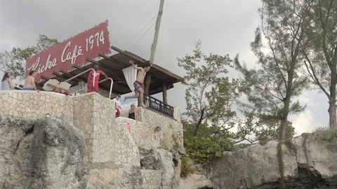 Cliff jumping at Ricks Cafe in Negril, Jamaica. Filmed in Super Slow Motion. Stock Footage 73138356